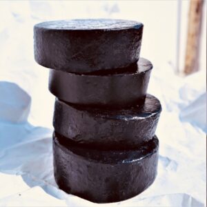 black_soap2 a pile of shiny round black soaps, handmade with activated charcoal