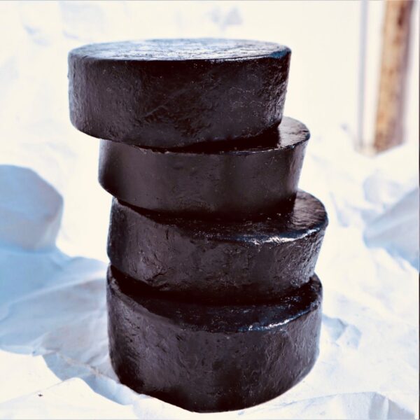 black_soap2 a pile of shiny round black soaps, handmade with activated charcoal